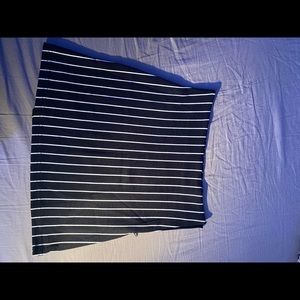 Black and white striped mini skirt. Zipper on back and slit on side.